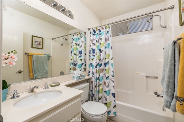 bathroom featuring vanity, toilet, and shower / tub combo with curtain