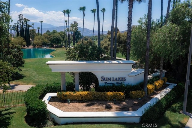 community sign with a lawn and a mountain view