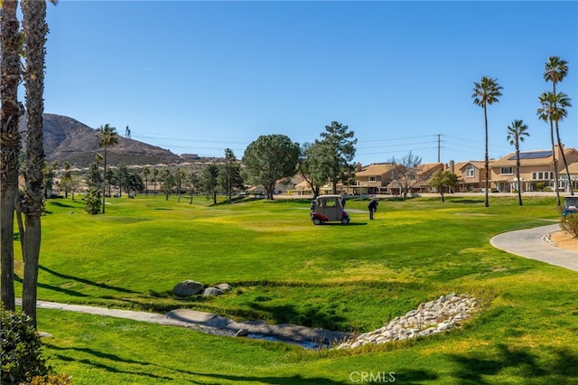 surrounding community featuring a mountain view, a yard, and a residential view