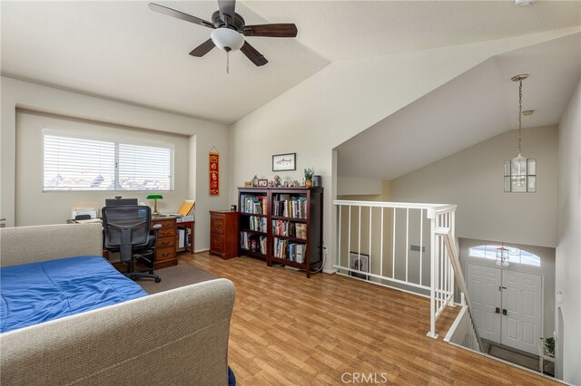 bedroom with light wood-style flooring, a ceiling fan, and vaulted ceiling