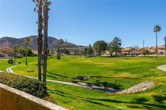 view of community featuring a yard, a mountain view, and a residential view