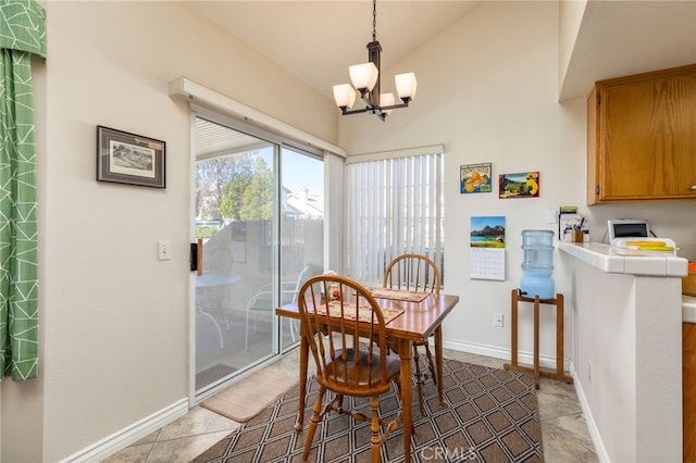 dining area with vaulted ceiling, baseboards, an inviting chandelier, and light tile patterned floors