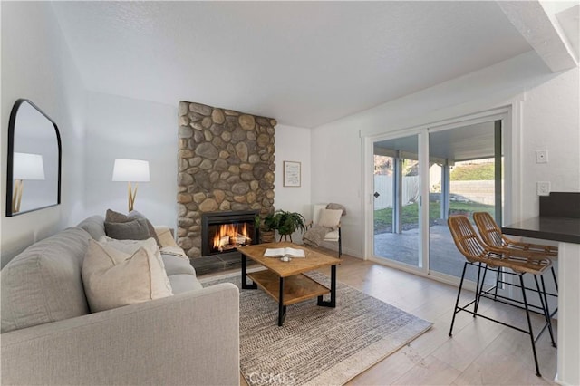 living room featuring hardwood / wood-style flooring and a fireplace