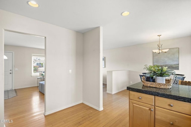 kitchen with tile countertops, light wood finished floors, baseboards, and recessed lighting