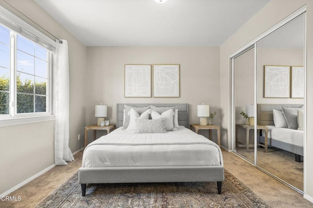 bedroom with carpet, a closet, and baseboards