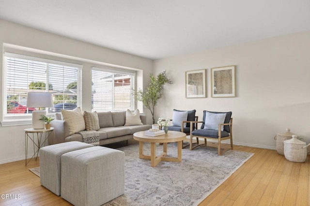 living area featuring light wood-style flooring and baseboards