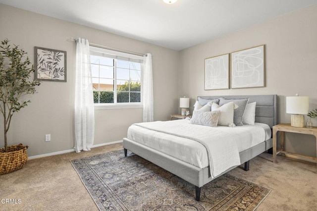 carpeted bedroom featuring baseboards