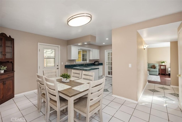 tiled dining area featuring sink