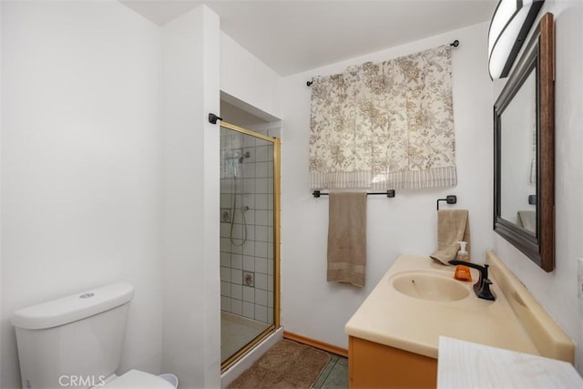 bathroom featuring toilet, vanity, tile patterned flooring, and a shower with shower door