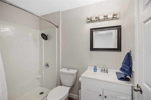 bathroom with vanity, toilet, and walk in shower