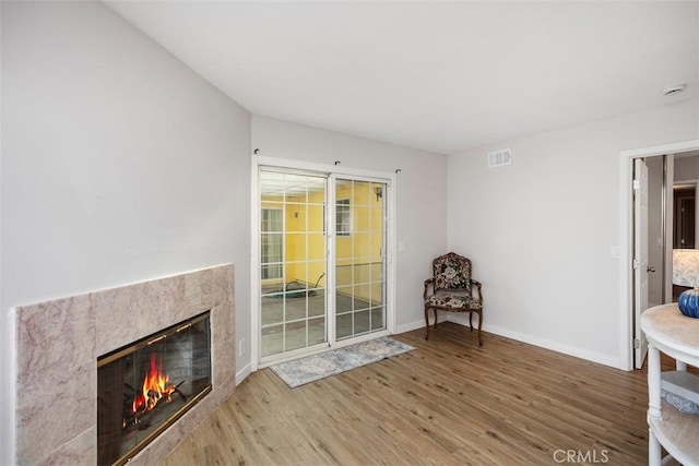 unfurnished room with hardwood / wood-style floors and a fireplace