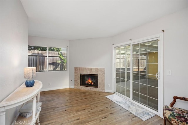 sitting room with a fireplace and hardwood / wood-style flooring