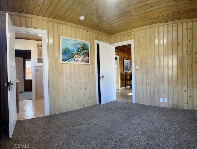 505 N Dr, Lebec, CA 93243 - carpeted empty room featuring wooden walls, wood ceiling, and tile patterned flooring