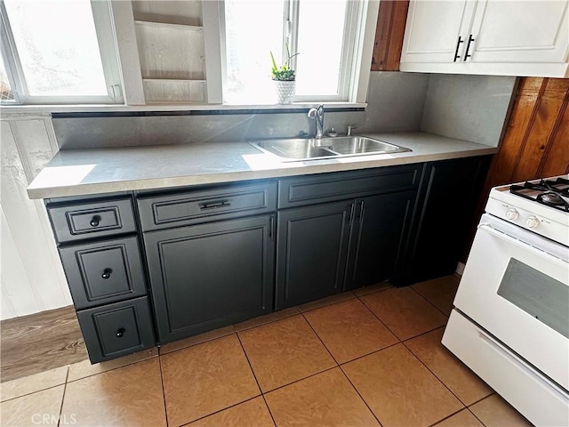 505 N Dr, Lebec, CA 93243 - kitchen featuring light countertops, light tile patterned floors, white gas range oven, and a sink