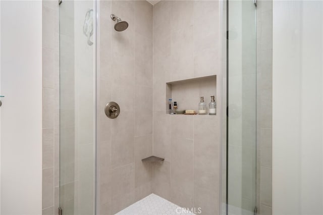 bathroom with a shower with shower door