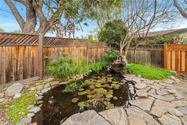 view of yard with a garden pond