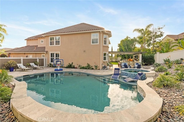 view of pool with an in ground hot tub and a patio area