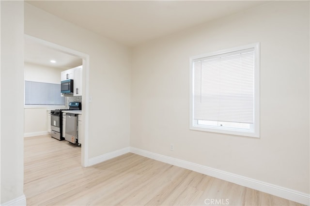 unfurnished room featuring light hardwood / wood-style flooring