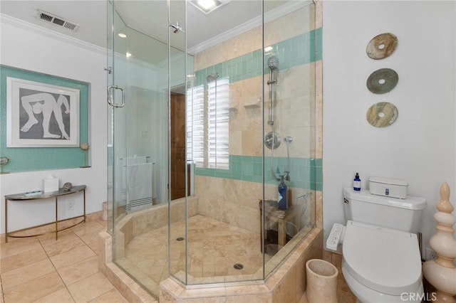 bathroom with tile patterned flooring, crown molding, toilet, and a shower with shower door