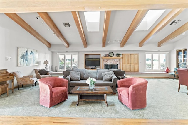 living room with visible vents, a wealth of natural light, and wood finished floors