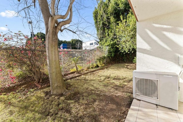 view of yard with ac unit and fence