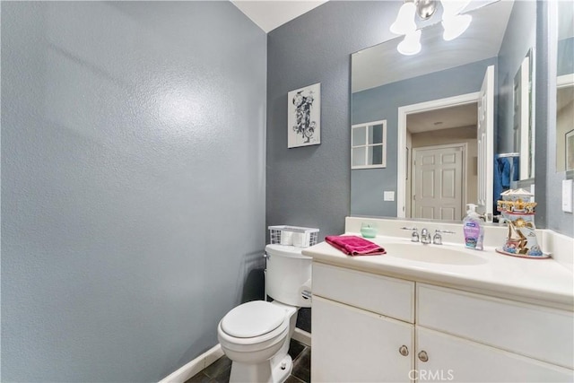 bathroom featuring toilet, vanity, and tile patterned flooring