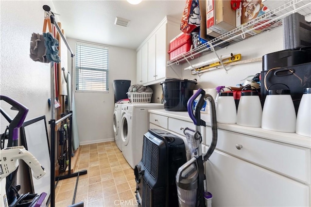 laundry area with cabinets, washer and dryer, and light tile patterned floors