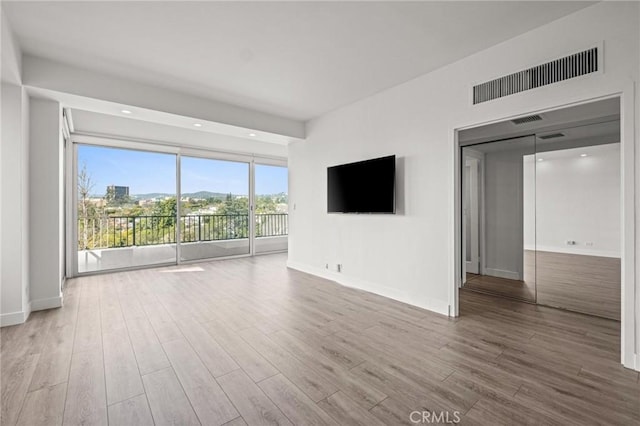 unfurnished living room featuring hardwood / wood-style flooring