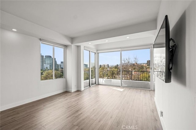 spare room with light hardwood / wood-style flooring