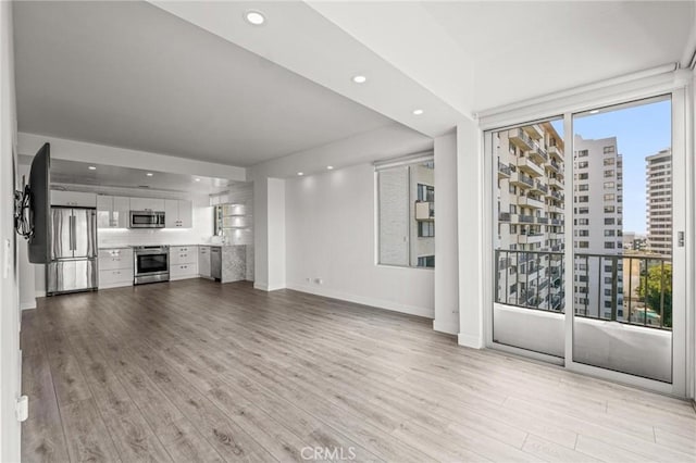 unfurnished living room with light hardwood / wood-style floors