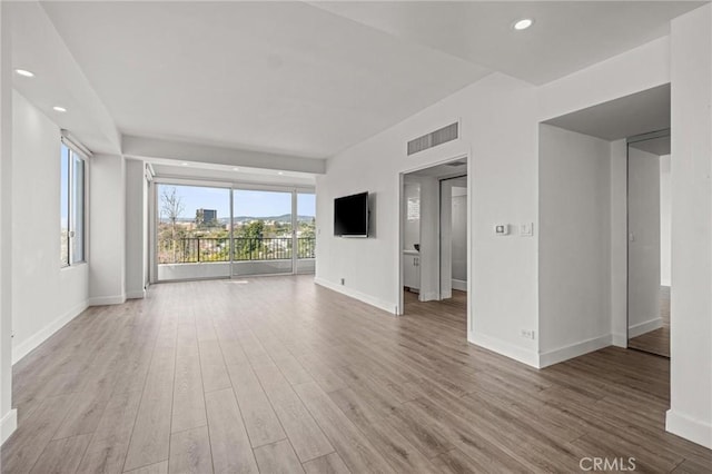 unfurnished living room with light hardwood / wood-style floors