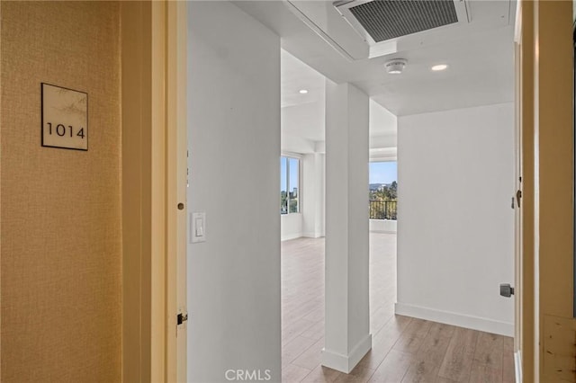 corridor with light hardwood / wood-style floors