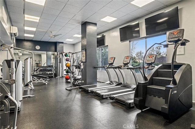 gym with a paneled ceiling