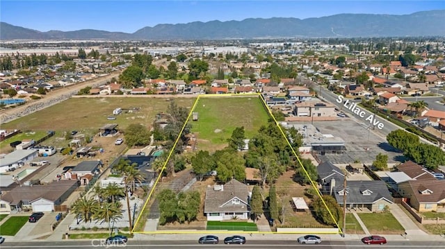 birds eye view of property with a mountain view