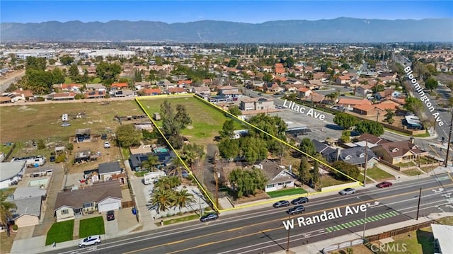 birds eye view of property with a mountain view