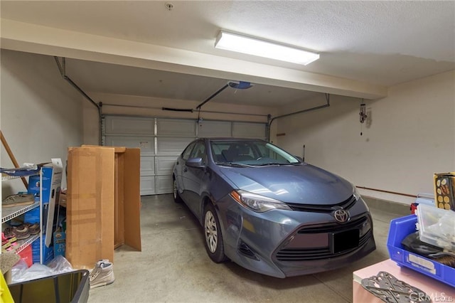 garage featuring a garage door opener and a carport