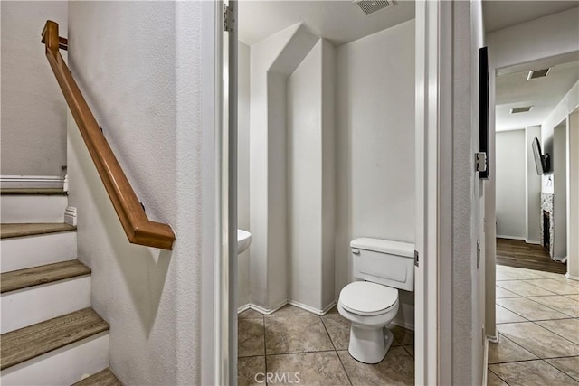 bathroom with tile patterned flooring and toilet