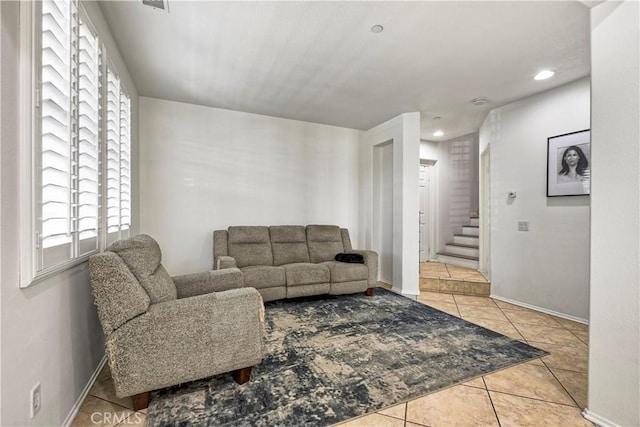 tiled living area with recessed lighting, visible vents, stairway, and baseboards