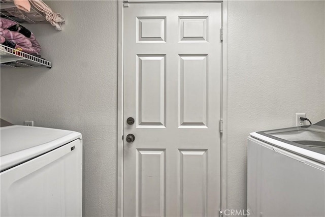 washroom with washing machine and dryer