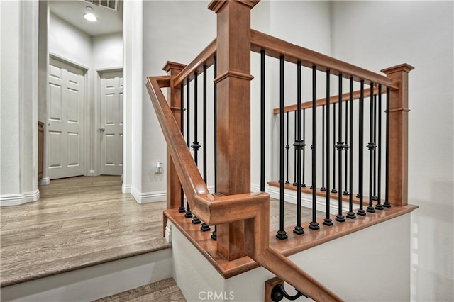 stairs with wood-type flooring