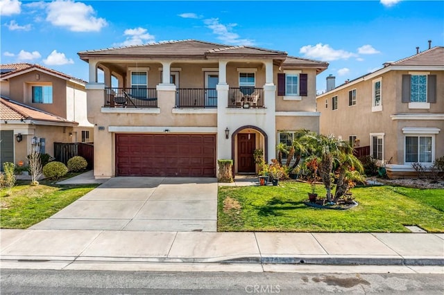 view of front of property with driveway, a front yard, a balcony, and stucco siding