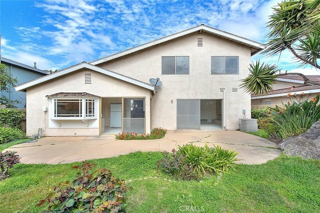 back of property featuring a patio area, a garage, driveway, and stucco siding