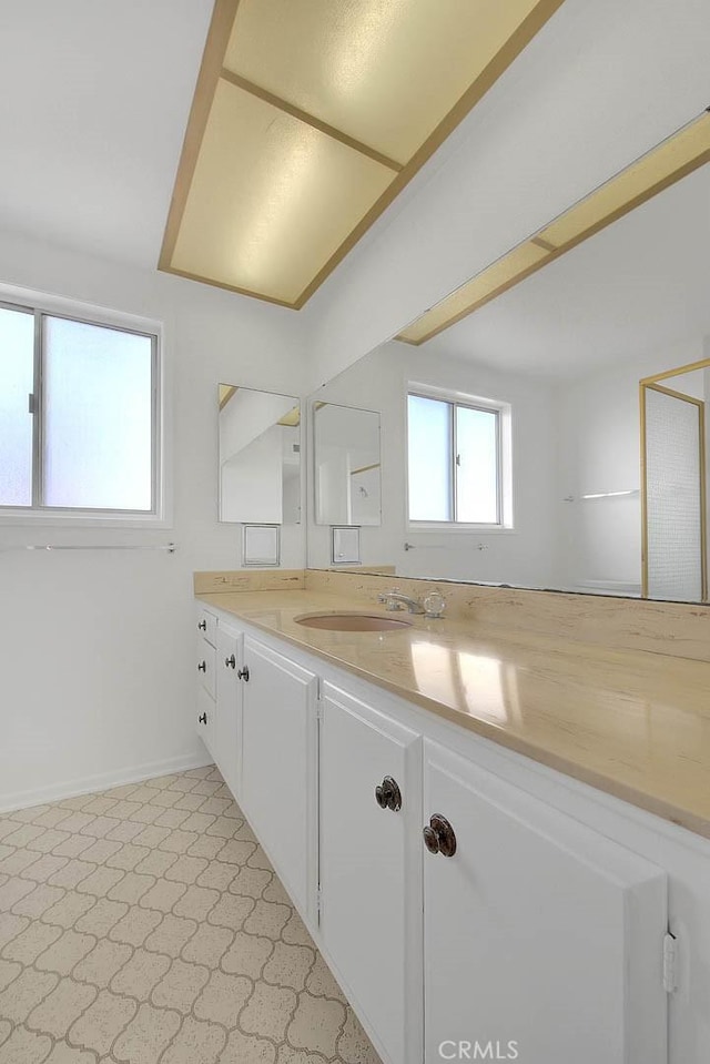 bathroom with baseboards and vanity