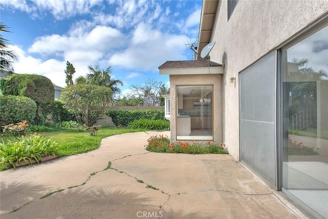 exterior space with a patio, a yard, and stucco siding