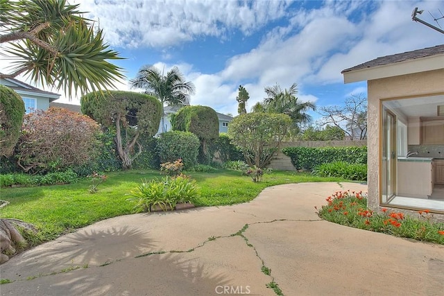 exterior space with a sink, a patio, and fence