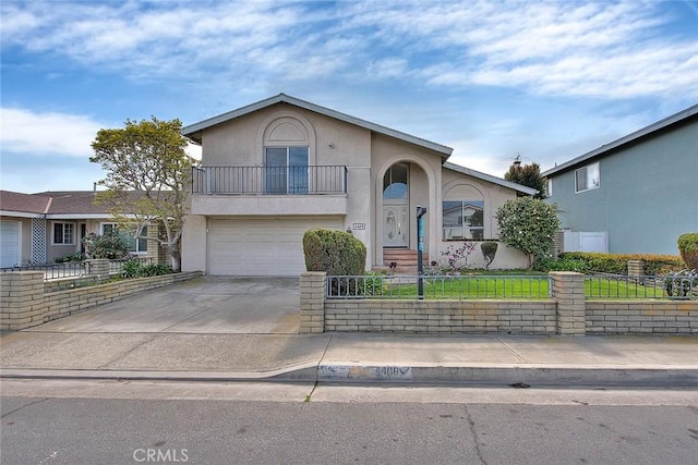 view of front facade featuring an attached garage, a fenced front yard, stucco siding, a balcony, and driveway