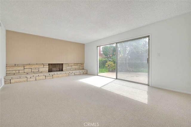 unfurnished living room featuring carpet floors and a textured ceiling