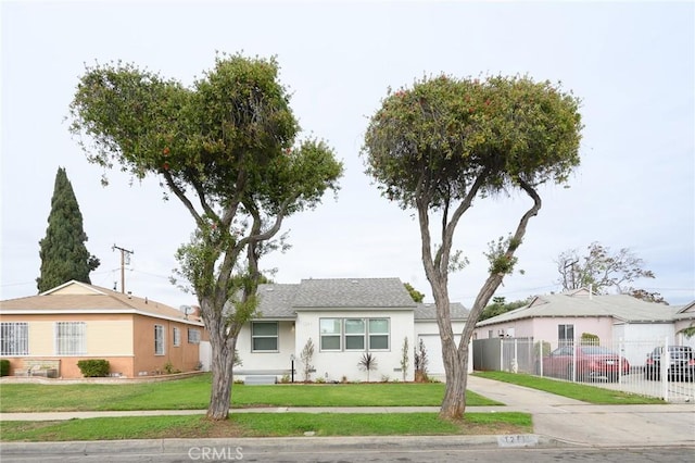 single story home featuring fence, a front lawn, stucco siding, and concrete driveway