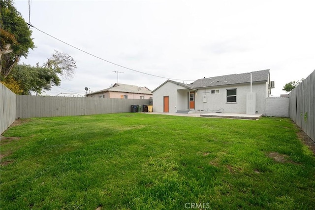 view of yard featuring a patio and a fenced backyard