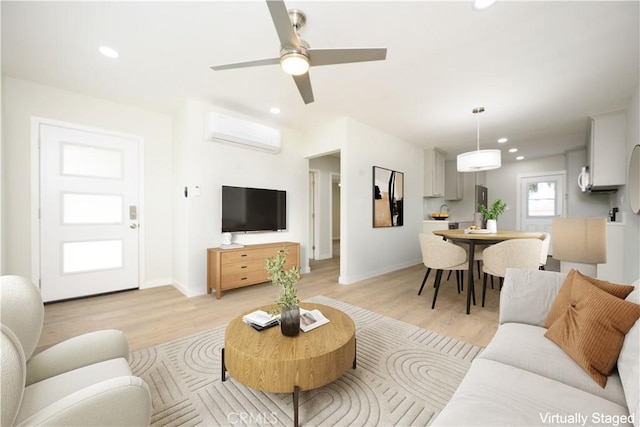 living area with light wood-type flooring, recessed lighting, and an AC wall unit